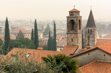 Skyline of Marostica, Italy, in a hazy winter afternoon seen from the footpath leading to the upper...