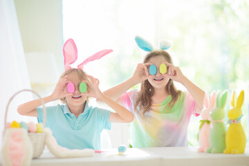 Kids on Easter egg hunt. Children dye eggs.