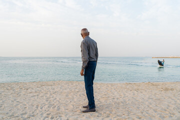 Senior man looking at the young man on jetski