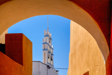 A vertical shot of church bells in Emporio village. Santorini, Greece. Church of Our Lady Messani or Church of Old Panaghia. This church built during the 16th century - obrazy, fototapety, plakaty