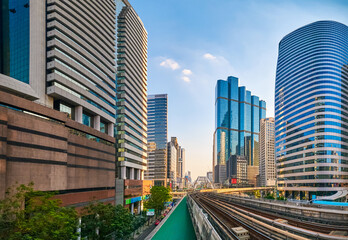 Fototapeta na wymiar Sunny day in business downtown, light train rails and skyscrapers. 