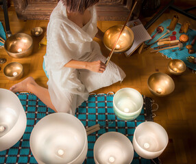 Woman in Crystal Singing Bowls in Sound Healing Therapy Session ,. A tranquil essence for mental...