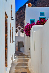 Fototapeta premium In the narrow streets of Emporio village, Santorini, Greece. The winding pathways in Kasteli, the castle are very narrow with steep stairs and very narrow doors and windows.
