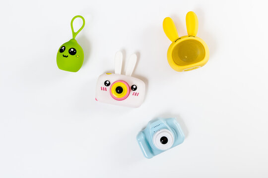 The gadgets for kids. Children's usefull toys: photo cameras, music speakers. White background.