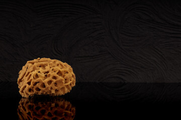 Ecological sponge for care, body wash with black background.
