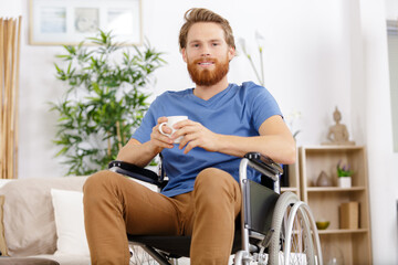 man in wheelchair having a coffee