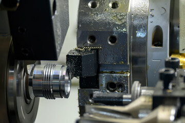 The multi-tasking CNC lathe machine swiss type thread cutting the metal pipe parts.