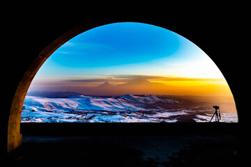 Arch and beautiful sunset. Mount Ararat and golden sunset can be seen through the arch