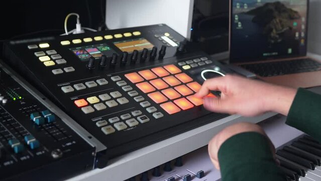musician creating new audio with a sound synthesizer in a recording studio, closeup. High quality 4k footage