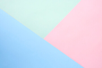 Abstract geometric paper background. Blue, pink and pale green. Flat lay, top view, copy space.