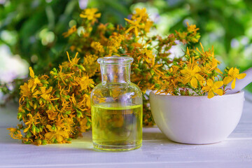 St. John's wort essential oil in a small bottle. Selective focus.