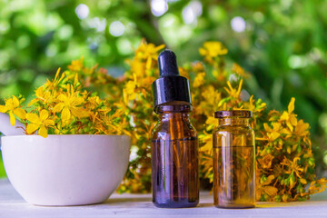 St. John's wort essential oil in a small bottle. Selective focus.