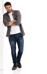 Waiting around for an opportunity. Full length studio shot of a handsome young man with his arms...