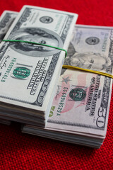 Three stacks of dollars. A lot of 100 and 50 dollar bills, close up