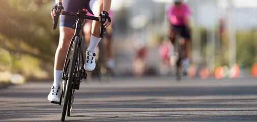 Female cyclist riding racing bicycle. Cycling competition, cyclist athletes riding a race	 - obrazy, fototapety, plakaty