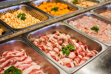 Selective focus on plenty choices of meat in pots for traditional charcoal grill BBQ style in all you can eat buffet.