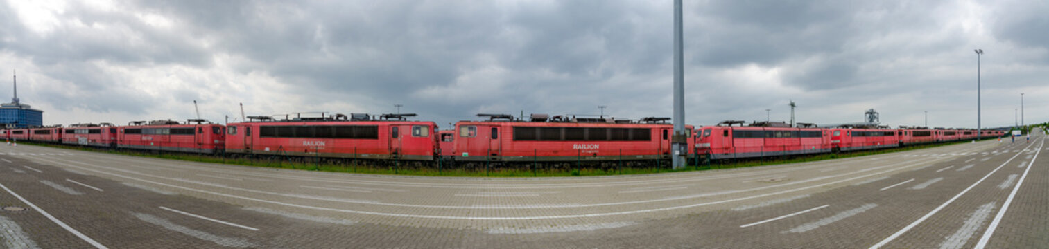 row of old red electric locomotives at the ferry port of Mukran near Sassnitz, Germany