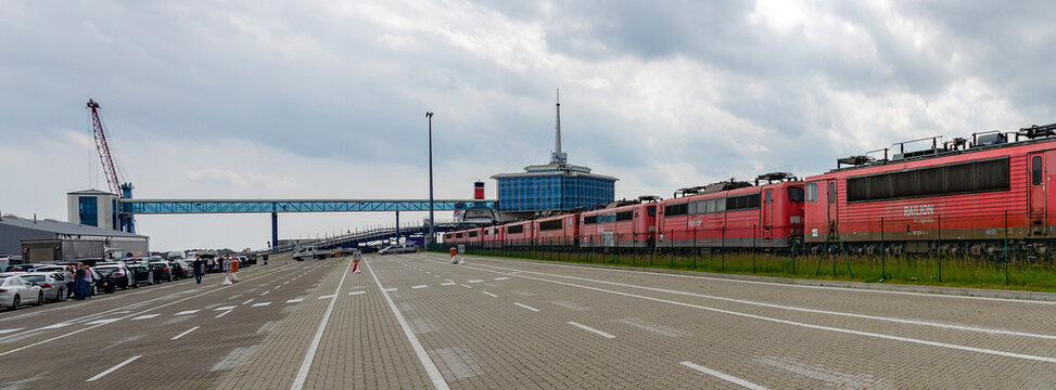 old red electric locomotives and waiting cars at the ferry port of Mukran near Sassnitz, Germany