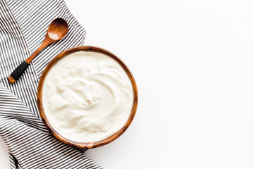 Fototapeta na wymiar Bowl of sour cream or yogurt. Dairy product background