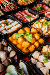 Selective focus on plenty choices of meat in pots for traditional charcoal grill BBQ style in all you can eat buffet.