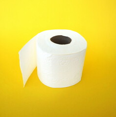Roll of toilet paper on the yellow background. Tissue for use in the toilet room, used for cleaning the dirt in the bathroom. People are stocking up toilet paper for home.