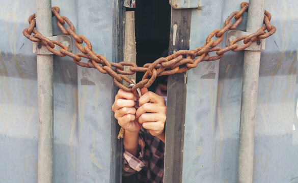 Woman trapped in cargo container wait for Human Trafficking or foreigh workers, Woman holding master key wait for holp help, woman chained to her wrist