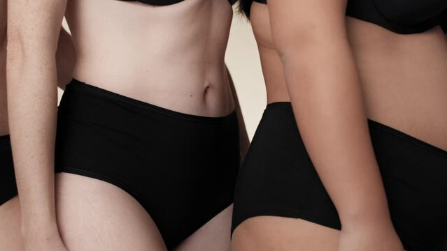 Close up of unrecognizable women in black underwear standing side by side. Shot with RED helium camera in 8K.  
