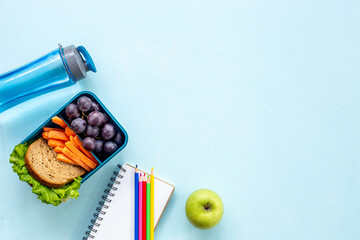 School lunch box with sandwich, fruits and water