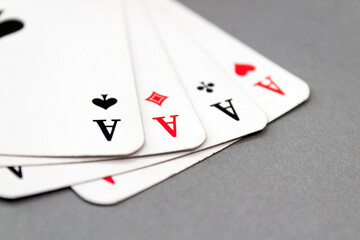 Four aces isolated on grey background