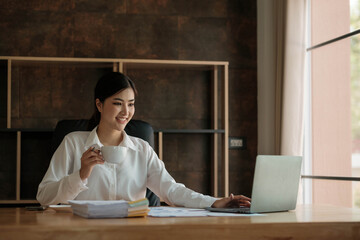 Business woman using calculator for do math finance on wooden desk in home and business working background, tax, accounting, statistics and analytic research concept..