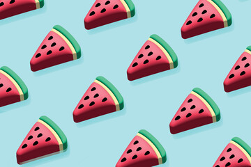 Pattern made with watermelon fruit on bright light blue background. Minimal food concept.
