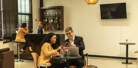 Two business workers are waiting and taking facility service at an exclusive airline lounge....