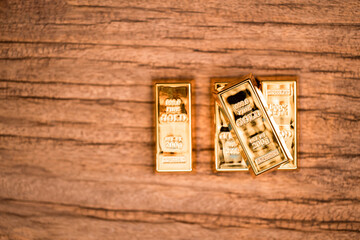 Stacking gold bar coins with increase put on the old wood in the office, Saving money and loan for prepare in the future concept.