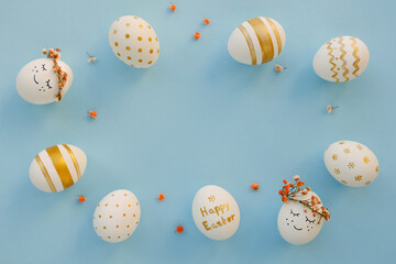 Easter background. Easter golden decorated eggs on blue background. Minimal easter concept. Flat Lay of Golden Easter Eggs