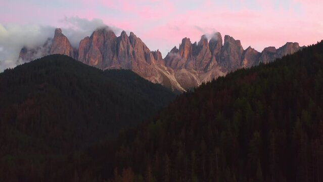 Aerial view of the beautiful massif of the Dolomites of Odle or Geisler group at pink sunset