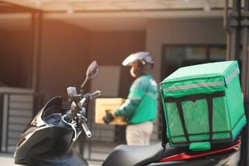 green rider parcel delivery man  of a package through a service send to home. hand holding consigns...