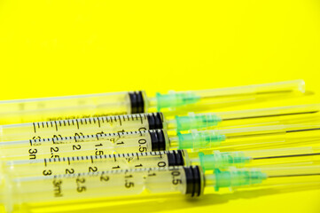 syringe and needle on yellow background