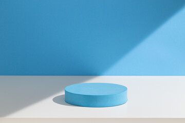 Round cylinder podium for products or cosmetics against light pastel blue background with shadows.