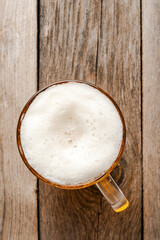 Beer glass on an old wooden table.