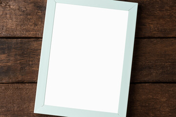 Empty picture frame on wooden background