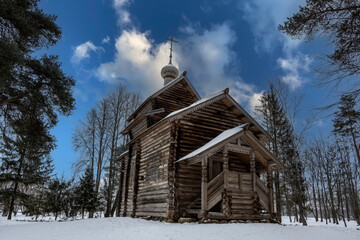 old houses and household buildings made of wooden beams according to old technologies in the vicinity of Veliky Novgorod in winter