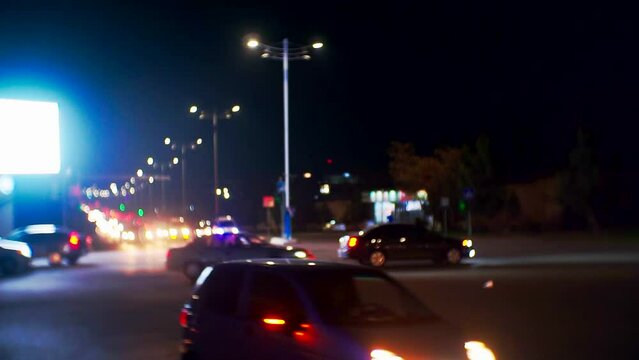 Modern City Life.many Cars With Headlights On Driving At Night On A Busy City Road.blurry Defocused Video.