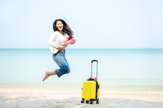 Summer Vacation. Lifestyle woman walking and jumping relax happy on beach tropical outdoor in summer day. Young people luxury and travel destination in holiday. Tourism chill leisure of trips
