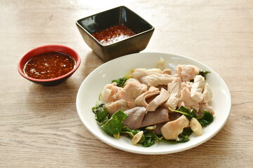 boiled slice pork meat and organ on plate dipping spicy and sour chili sauce 