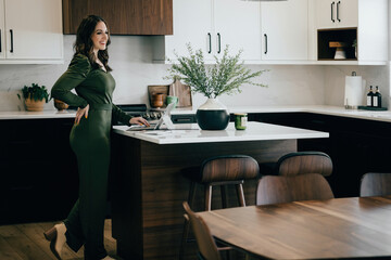 Fashionable brunette Caucasian woman posing in midcentury modern home