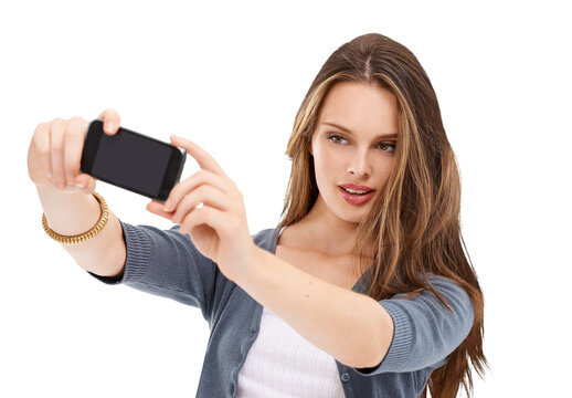 A tech-savvy user capturing a memorable moment for social media by taking a selfie with her cellphone, carefully examining the camera clarity  isolated in a transparent PNG background.