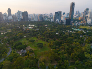 Aerial view Lumpini central park with modern office building sunset sky downtown