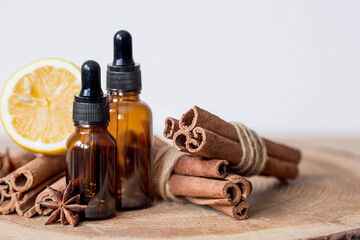 Aromatherapy. Massage and spa. Cosmetic bottles with essential oil, cinnamon sticks, lemon and star...
