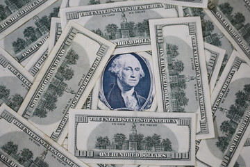 Portrait of Washington of a dollar surrounded by hundred dollar bills. U.S. economic profile,...