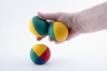 childrens entertainer with  three leather juggling balls isolated on a white background